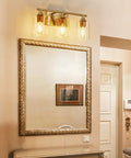 Three Light Vanity Light Fixtures Matte Black Finish With Clear Glass Shades Farmhouse Style Wall Lamp in bathroom.