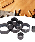 Eight Piece Round Leather Cutting Die Set With Alloy Steel Punching Tools 25 To 60mm shown on a leatherwork table.