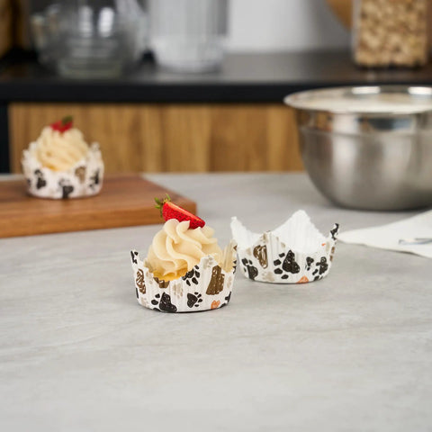 Cupcakes in paw print design liners showcasing Greaseproof Cupcake Liners 4000 Pack, 4 Oz Disposable Muffin Cups For Oven Or Freezer.