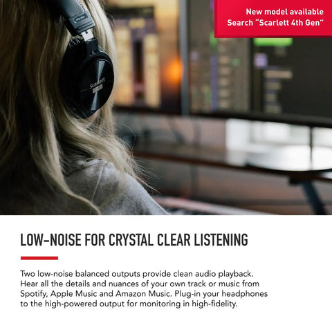 Person using headphones connected to Scarlett 2i2 3rd Gen USB Audio Interface for low-noise, high-fidelity audio in studio setting.
