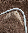 One Inch PVC Lock Flexible Repair Coupling for Schedule 40 PVC Pipe installed in garden soil; O-ring ensures watertight seal.