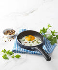Mini 4.6 Inch Nonstick Aluminum Fry Pan For Single Eggs And Tiny Servings with fried egg on white background