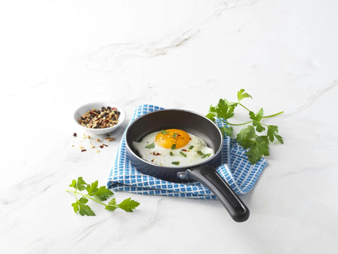 Mini 4.6 Inch Nonstick Aluminum Fry Pan For Single Eggs And Tiny Servings with fried egg on white background