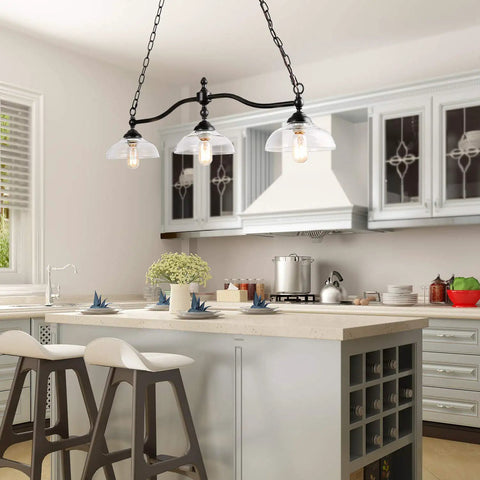 Farmhouse Chandelier Hanging Light Fixture In Rustic Black Metal With Three Bowl Shaped Clear Glass Shades over kitchen island