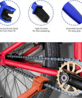 Five Piece Bike And Motorcycle Chain Cleaning Kit with sprocket scraper, sprocket brush, three chain cleaning brushes shown on bike