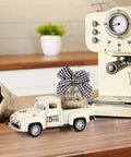 Metal Coffee Truck With Burlap Sack Farmhouse Kitchen Decor Mini Pickup on coffee counter next to espresso machine.
