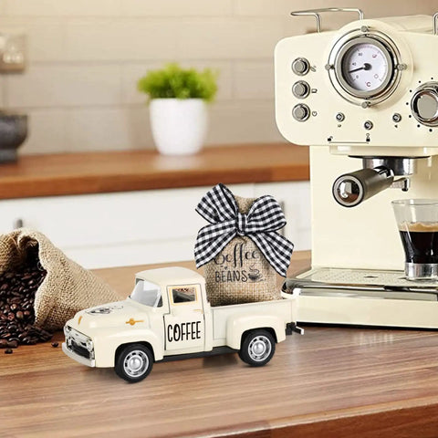 Metal Coffee Truck With Burlap Sack Farmhouse Kitchen Decor Mini Pickup on coffee counter next to espresso machine.