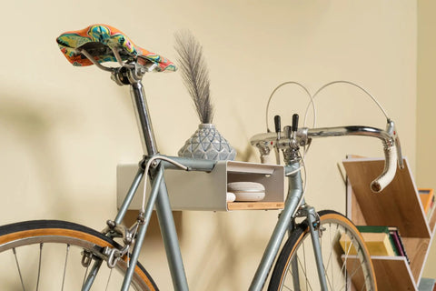 Wall Mounted Bike Rack With Bamboo Shelf For Indoor Storage And Decor holding a bike, vase on top, in a living room