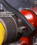 Close-up of Rescue Tool 87 Lightweight 8.88 Inch Firefighter Tool using spanner wrench on hose coupling for quick access.