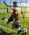 4-In-1 Universal Fence Mount Kit With Tripod Adapter For Recording On The Go holding smartphone on soccer field fence