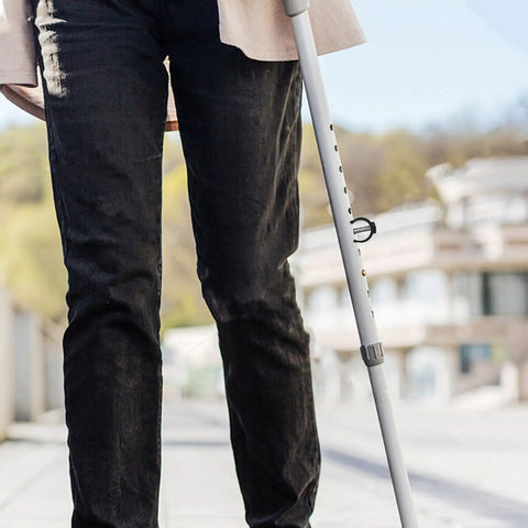 Person using crutch with Eight Pieces C Shaped Locking Clips for walking aid accessories on 22mm round pipe outdoors.