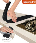 Close-up of hands installing Stove Gap Cover 21 Inch Silicone Gap Filler for Kitchen Counter and Stove Heat Resistant Easy Install Easy Clean