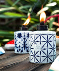Tie Dye Glass Tabletop Torches 3 Pack For Outdoor Patio, Backyard And Garden Lighting, two blue torches lit on wooden table