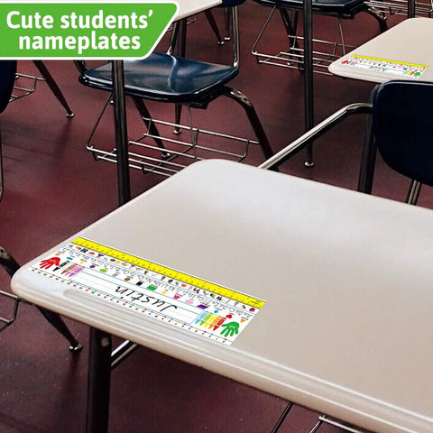 Classroom desk with Self Adhesive Dope Desk Nameplates For Primary Classrooms Pack Of 36 With Manuscript Alphabet Upper And Lower Case Letters 26 Alphabet Pictures 16 Shapes Stroke Lines 13.8 X 4 Inches Colorful Desk Tags visible.