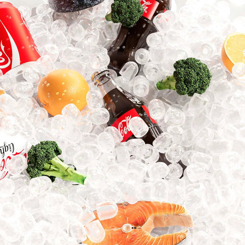 Ice-filled mix: Coca-Cola bottle, broccoli florets, orange half, and shrimp