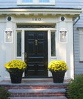 Front porch with Auto On Outdoor Wall Lantern With Dusk To Dawn Sensor Seeded Glass Sconce, white finish, and black door.