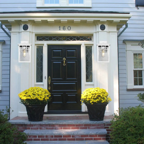 Front porch with Auto On Outdoor Wall Lantern With Dusk To Dawn Sensor Seeded Glass Sconce, white finish, and black door.