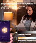 Woman using an app to control GU24 Smart LED Bulbs With RGBCW Color Changing, 16 Million Colors, 10W 900LM, in a cozy room setting.