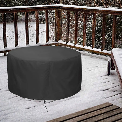 48 Inch Fire Pit Cover For 45 To 48 Inch Round Fire Pits Waterproof Windproof Dustproof UV Resistant Heavy Duty Outdoor Patio Shield Fits Most Fire Pit Tables Black in snowy patio setting.