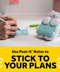 Person writing on paper next to cat themed pop up sticky note dispenser with 3x3 pink notes 45 sheets easy refill cute desk organizer