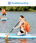 Person paddleboarding with bright orange 35L Swim Buoy Dry Bag Floating Backpack With Shoulder And Waist Straps.