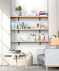 Living room with bookshelves supported by Heavy Duty 10 Inch L Shaped Shelf Brackets 6 Pack, holding books and decor.