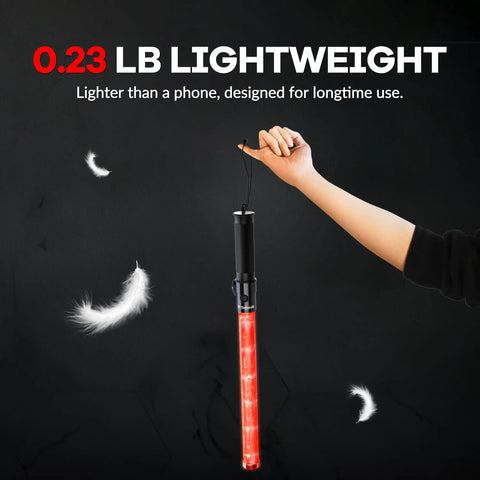 Person holding a 10 Pack 21 Inch Lit LED Traffic Safety Wand With 3 Flashing Modes For Parking Guides And Air Traffic Style Signals Lightweight PVC Baton That Runs On 2 C Batteries Not Included alongside floating feathers indicating its lightness.