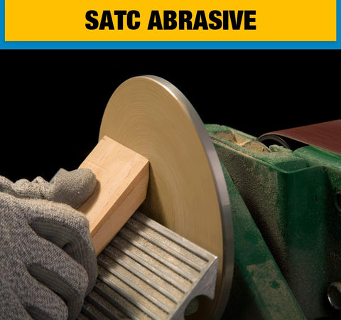 6-inch PSA sanding disc on a grinder; adhesive-backed aluminum oxide for wood sanding.