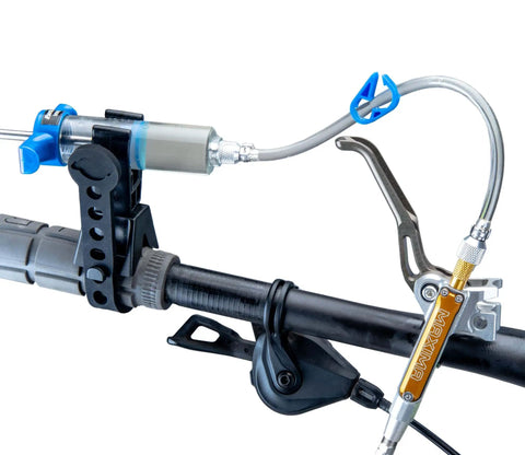 BKM12 Hydraulic Brake Bleed Kit For Mineral Oil With Dual Syringes on bike handlebar, showing syringe mount and hose attachment