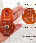 Orange zipline pulley for rescue, climbing, and hauling featuring load capacity markings, in a hand, showing CE certification details.