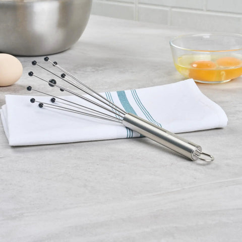 Stainless Steel Ball Whisk With Silicone Tips 10.5 Inch 24 Pack Non Scratch Dishwasher Safe lies on a kitchen towel.