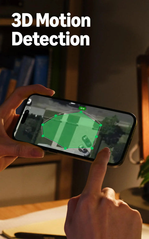 Person interacting with smartphone motion detection feature of the Outdoor Cam Pro Plug In Security Camera For Home Or Biz Surveillance Retinal 4K Video With Wide Angle And 10X Enhanced Zoom Low Light Night Vision White.