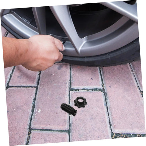 Person installing Spare Tire Hold Down Bolt For Secure Mounting, Fits Volkswagen Models, next to car wheel