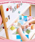 Child playing with Hands On Geometry Kit With 12 Geometric Solids And 12 Folding Nets, multicolored 3D shapes, and folding cards.