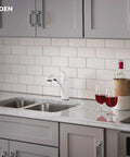 Brecklyn Glacier White One-Handle Single-Hole Kitchen Faucet With Pull-Out Sprayer Power Clean Reflex System installed on countertop
