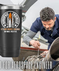 Space Themed 20oz Stainless Steel Tumbler With Lid, Double Wall Vacuum Insulated Travel Coffee Mug For Men, Hilarious It's Not Rocket Science Oh Wait Yes It Is Quote With Rocket Launch Logo Gift displayed beside engineer working on machinery.