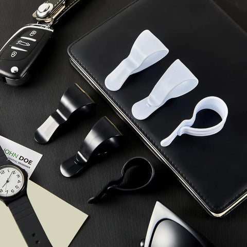 12 Pack Car Visor Clips For Sunglasses Holder And More Multipurpose Vehicle Visor Accessories White And Black Durable Clips displayed on a desk with keys and watch.