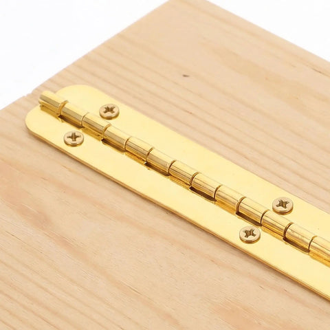 Beefy 8Pcs Heavy Duty Continuous Piano Hinges with pre drilled holes in gold iron installed on a wooden surface