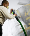 Man using Dust Busting Vacuum Enabled Sanding Block 80 By 200 Mm For Handheld Smoothing on a curved surface with dust extraction hose.
