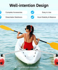 Woman in red kayak using Portable Kayak Stabilizers Kit for Most Kayaks and Canoes with Quick Release Outriggers on calm water.