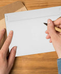 A4 Gray White Self Sealing Paper Mailing Envelopes Thickened For Documents And Photos 30 Pack with easy seal flap on desk