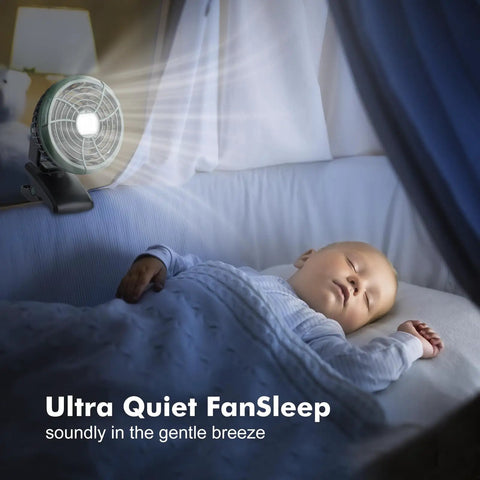 Sleeping baby next to Clip On Camping Fan With LED Lantern Magnetic Base and Hanging Hook, casting soft light.