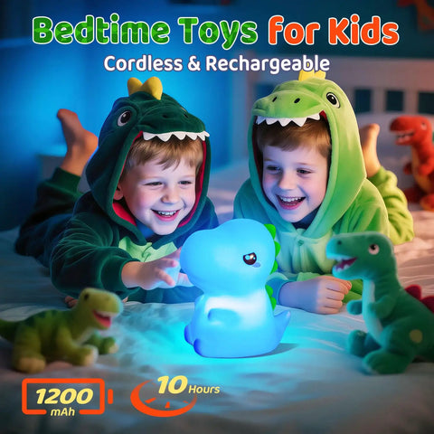 Two children in dinosaur pajamas playing with the Totally Adorable Dino Night Light For Kids 3 To 8 Sixteen Color Silicone Dimmable Battery Operated 12 Hour Use Dino Toy Night Light For Boys Girls Toddlers Bedroom Decor Gift on a bed.