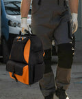 Person carrying Rolling Tool Backpack With Wheels, Heavy Duty 37 Pocket Organizer For Electricians, Contractors, HVAC Pros, And DIYers.
