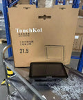 21.5 Inches Industrial Touchscreen Panel PC Running Windows 11 Pro With Intel Celeron J6412 Chipset on display with packaging in warehouse.