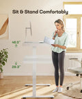 Woman using Glass Standing Desk With Drawer, 48 By 24 Inch Electric Height Adjustable Sit Stand Desk With One Piece Tabletop And USB Ports