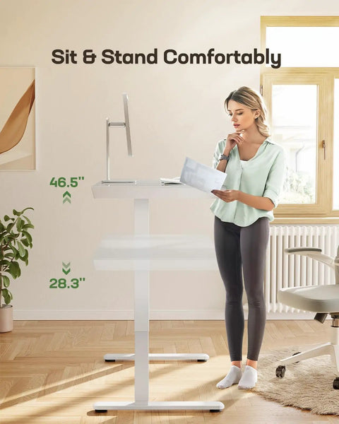 Woman using Glass Standing Desk With Drawer, 48 By 24 Inch Electric Height Adjustable Sit Stand Desk With One Piece Tabletop And USB Ports