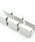 Angled front view of five white aluminum Nema23 motor mounting brackets with U-channel slots, 57x57x50mm
