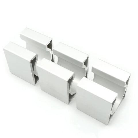 Angled front view of five white aluminum Nema23 motor mounting brackets with U-channel slots, 57x57x50mm