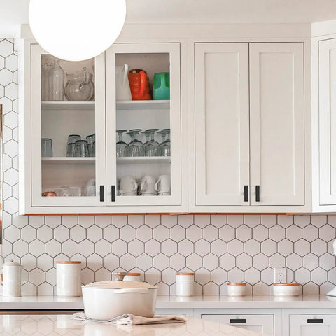 White kitchen cabinets with 40 Pack Dope Matte Black Square Cabinet Knobs And 2 Inch Pulls for single hole cabinets installed.